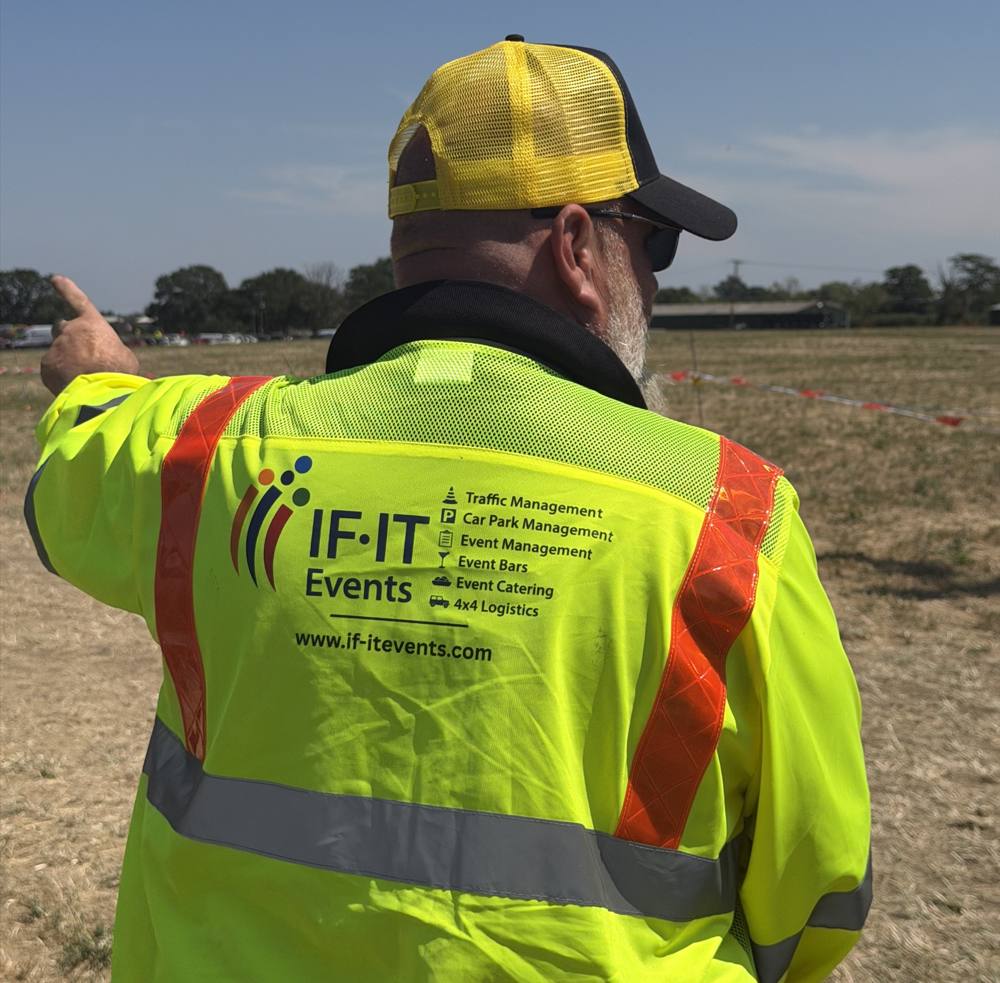 IF-IT Events staff member in branded hi-vis jacket directing on site