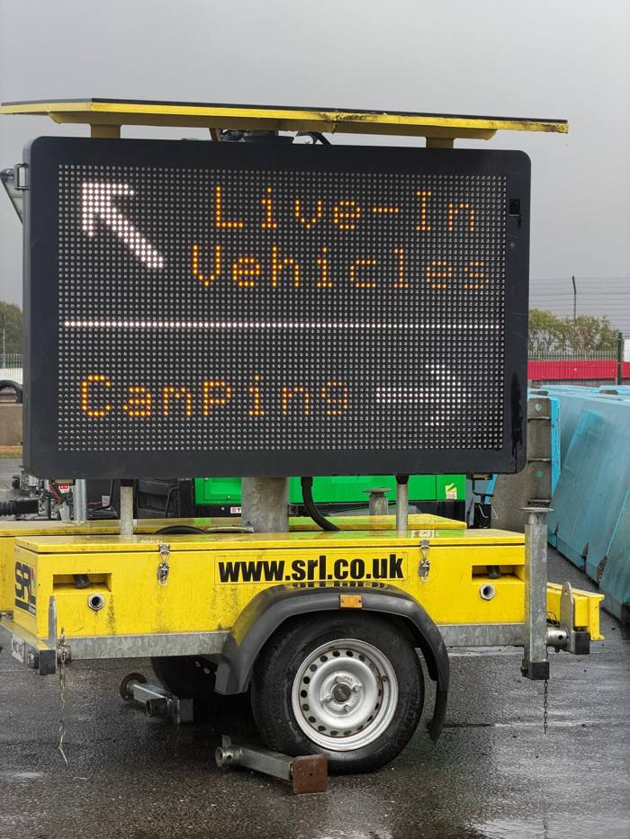 Mobile sign directing live-in vehicles and camping
